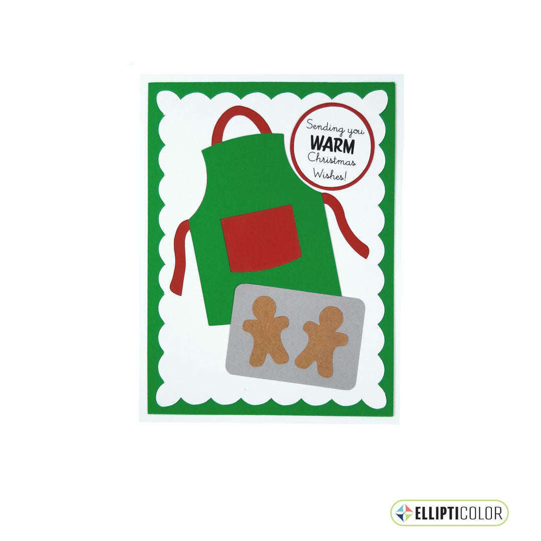 Christmas card with a green apron, gingerbread men on a baking sheet, and 'Sending you warm Christmas Wishes' text.