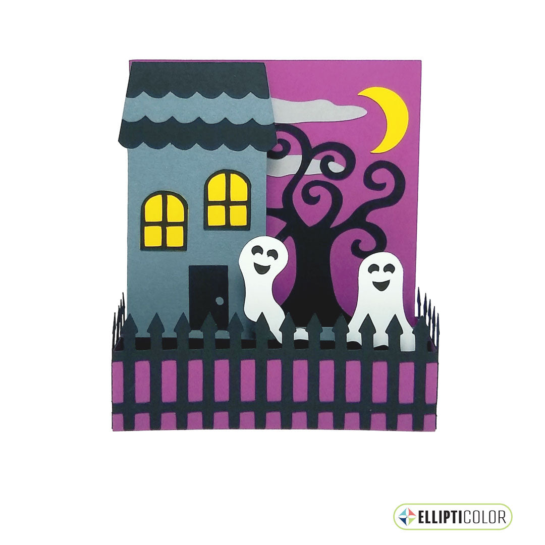 A Halloween themed box card with a haunted house, fenced yard, friendly ghosts, tree and moon.