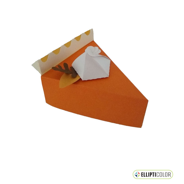 Paper craft pumpkin pie shaped box garnished with whipped cream and fall leaves.