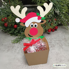 Reindeer-shaped gift box with candy inside, decorated with a Santa hat and antlers, against a Christmas garland background.
